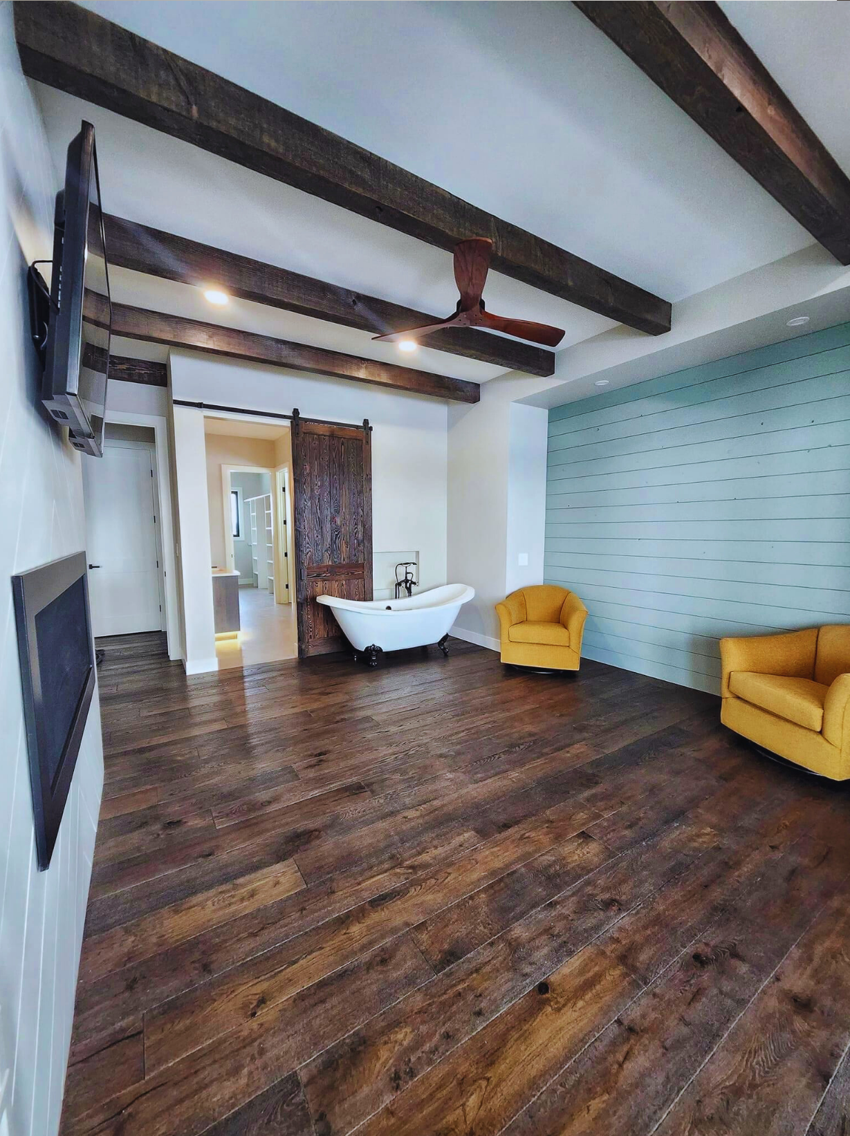 SRL flooring, beams and millwork installed in a residential interior.